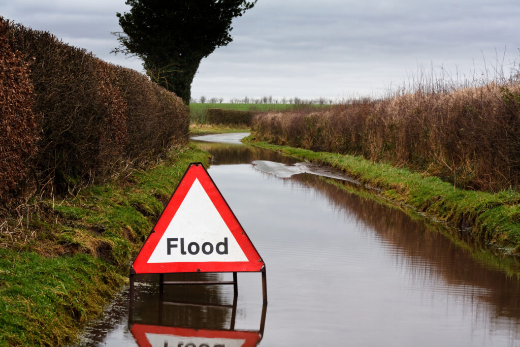 flood-warning-sign-on-flooded-country